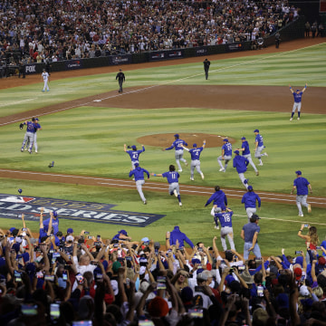 The Texas Rangers storm the field after the last out on Wednesday night, to celebrate the first World Series title in franchise history. The Rangers defeated the Arizona Diamondbacks in five games to win it all, with shortstop Corey Seager named series \"M